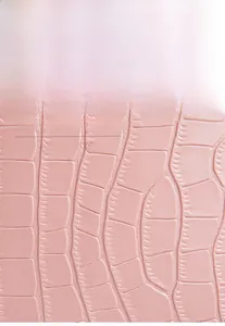 Detailed macro view of pink crocodile pattern embossed leather for crossbody bucket bag