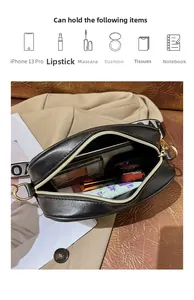 Detailed view of black cross-body bag interior showing space for phone and makeup