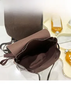 Top view of deep brown mini backpack with large capacity interior and drawstring details