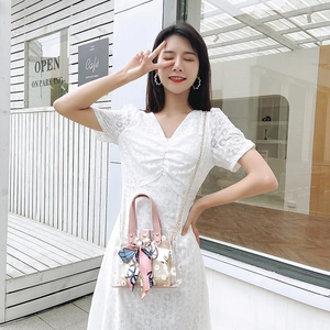 Chic transparent PVC tote with woven straw interior and floral scarf decoration