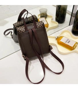 Detail view of vintage brown mini backpack with geometric prints and gold hardware buckles