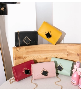 Detailed view of square lock crossbody bags in five colors with gold chain straps