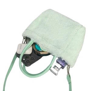 Mint green faux fur mini handbag with crossbody strap showing internal storage capacity