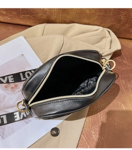 Top view of black faux leather square bag showing interior lining and wide LOVE strap