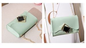 Detailed close-up of mint green PU leather bag with wave edges and gold square lock