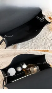 Vue intérieure du sac bandoulière en cuir noir montrant sa grande capacité et sa doublure