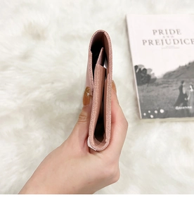 Side view of soft pink leather long wallet with multiple compartments and neat stitching