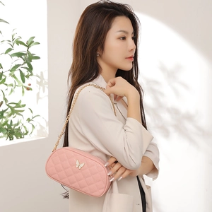 Pink quilted crossbody bag with golden chain and white butterfly ornament for women
