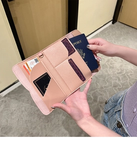 Detail view of pink bifold wallet interior showing passport slot and multiple card holders