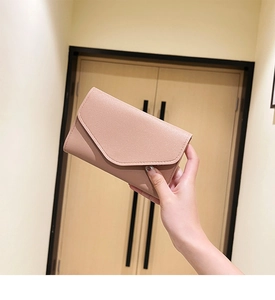 Close-up of pink bifold envelope wallet in PU leather with delicate stitching detail