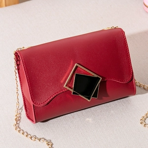 Red matte leather chain crossbody bag featuring a unique double square geometric gold buckle