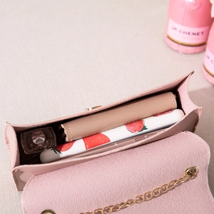 Pink mini crossbody bag with gold chain strap showing spacious interior capacity