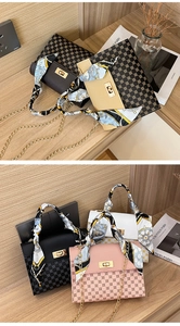 Close-up of elegant mini handbag with floral scarf handle and gold chain strap