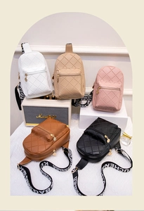 Close-up of diamond quilted crossbody bags in five colors with wide graphic straps