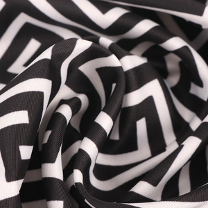 Fashionable black and white geometric print satin scarf with elegant draped texture