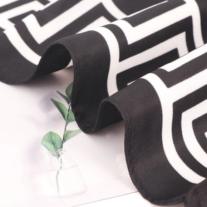 Silk square scarf with black and white geometric pattern and elegant satin finish