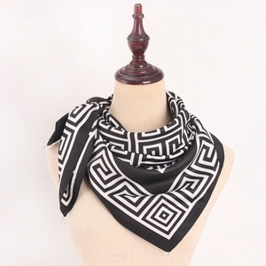 Detailed view of black and white geometric Greek key pattern on high-quality satin scarf