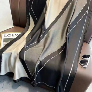 Elegant geometric print silk scarf with black and white rhombus patterns and silky texture