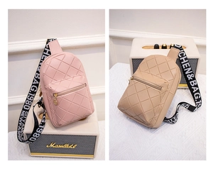 Close-up of diamond-quilted crossbody bags in pink and khaki with logo webbed straps