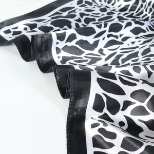 Close-up of leopard print satin scarf showing soft silk texture and glossy finish