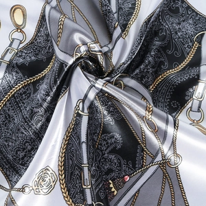 Elegant 60cm silk-like scarf featuring chain and paisley print in black, white, and gold