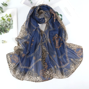 Navy chiffon leopard print scarf with gold chains on white background with greenery