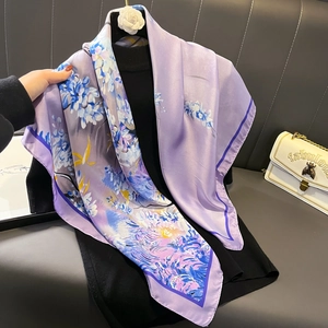 Satin floral silk scarf with purple and blue patterns on a black high-neck sweater
