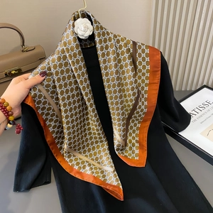 French style 70cm silk scarf with geometric chain patterns and orange border on a sweater