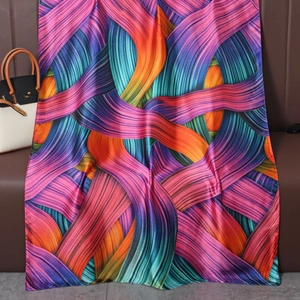Detail of colorful striped satin scarf with silky texture and vibrant geometric patterns