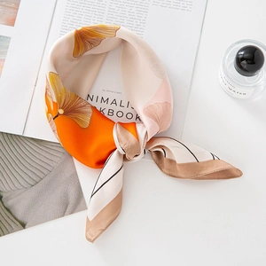 Elegant silk scarf with orange ginkgo leaf pattern and stylish black border accents