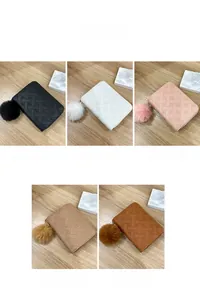 Quilted heart print wallet color display with fluffy pompom keychains in five colors