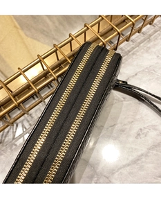 Détail d'un portefeuille long en cuir noir avec deux fermetures éclair dorées et dragonne