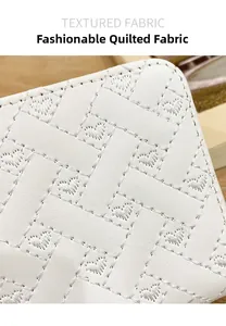 Detail of white quilted faux leather with heart patterns and textured fabric finish