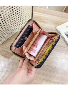Detail view of small zip wallet showing multiple card slots and organized interior