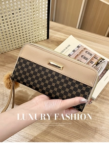 Detail of long floral print wallet with wrist strap and brown decorative pompom