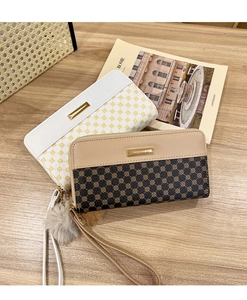 Detail of floral patterned zip-around wallets with elegant pompom and wrist strap charms