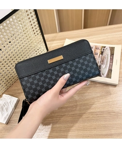 Close-up of women's long PU leather wallet with chic geometric print and wrist strap