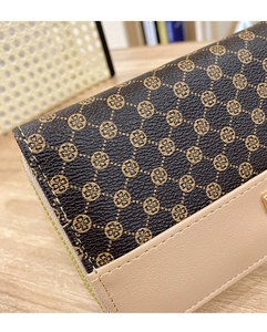 Detail shot of vintage pattern long wallet showing textured leather and zipper closure