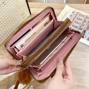 Brown leather wallet for women with pompom charm and multi-card slot interior design