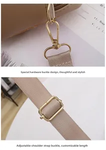Detail of adjustable fabric shoulder strap with golden metal lobster clasp and hardware