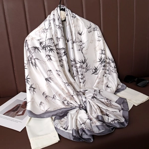 Satin silk scarf with Chinese bamboo leaf print on a white shirt with leather background