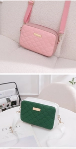 Detail of small crossbody bags with fish scale quilting and gold metal hardware