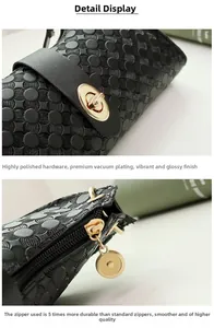 Detail of high-polished gold metal lock and durable zipper on black leather handbag