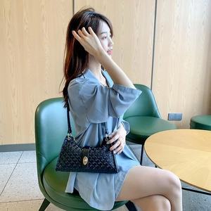 Retro black baguette shoulder bag with textured chain pattern and golden buckle