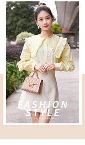 Outdoor street style fashion shot of women's pink crossbody square bag with floral patterns