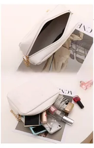 Internal view of quilted white square bag showing storage capacity for daily essentials
