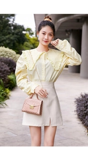 Outdoor look of light yellow shirt with ruffle collar and printed square handbag