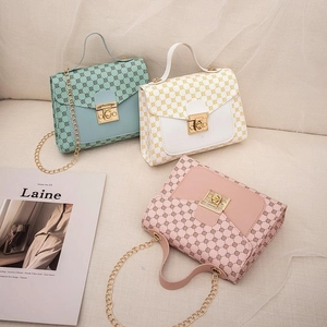 Three elegant patterned handbags in green, yellow and pink with gold chain straps