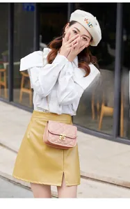 Close-up of pink quilted leather crossbody bag with gold-tone metal chain and twist lock