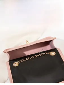 Top view of pink quilted chain bag showing spacious main compartment and metal lock